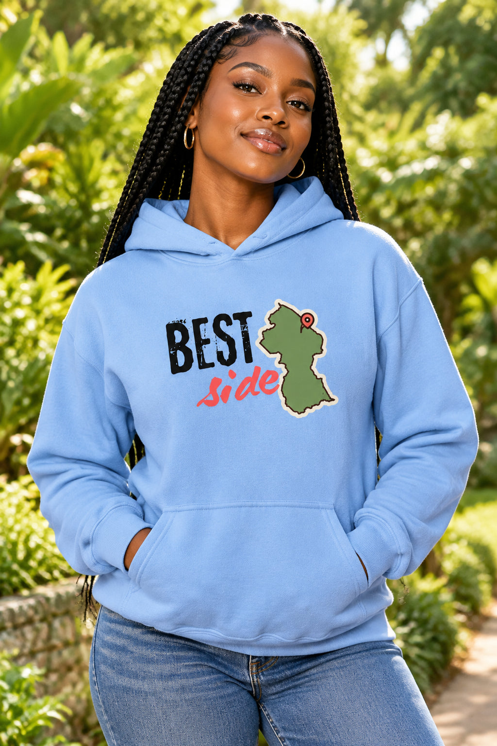 A light blue pullover hoodie with a graphic on the chest that reads 'BEST side' in black and red text next to an olive green Guyana map outline with a red pin, shown on a plain white background.