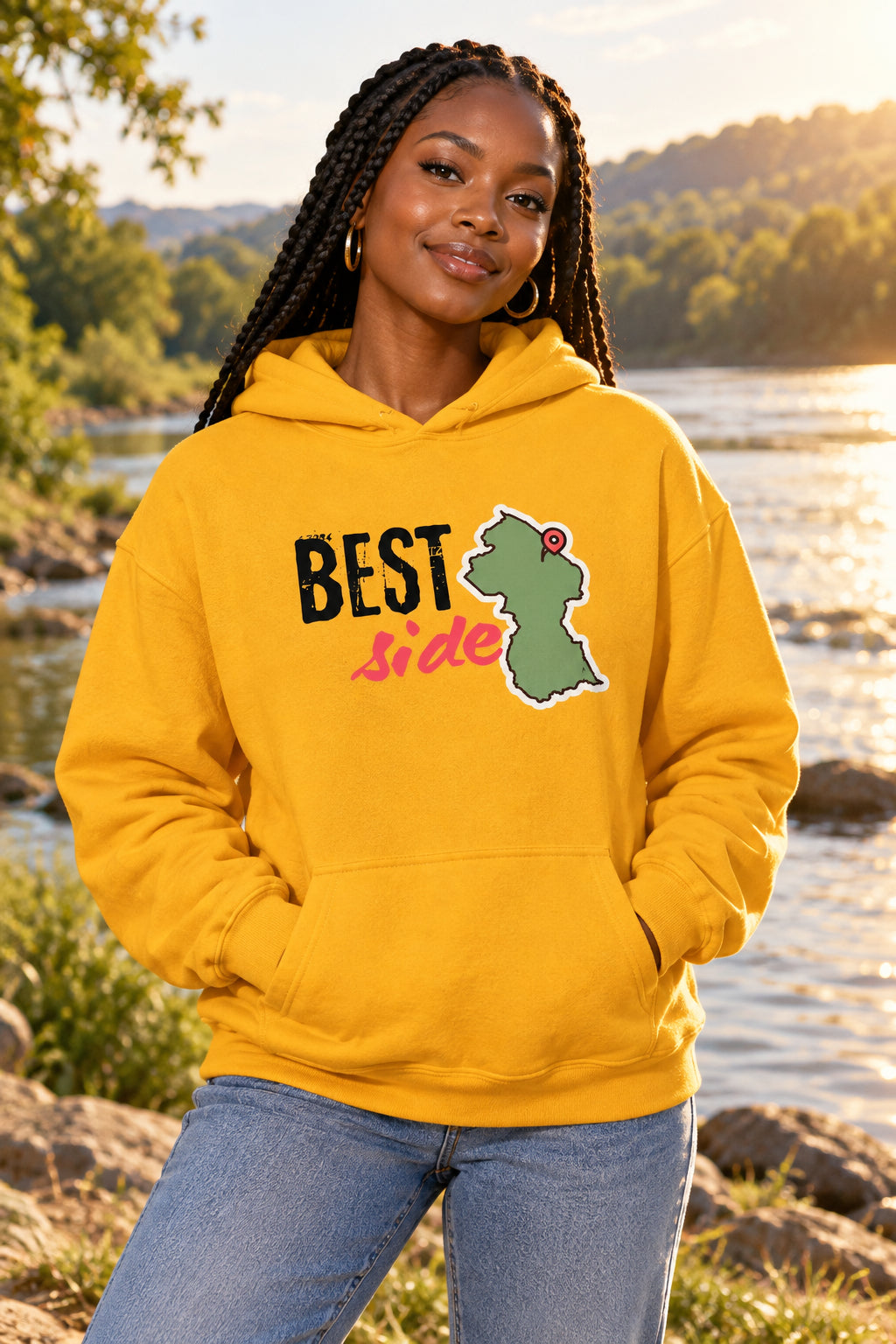 A yellow pullover hoodie with a graphic on the chest that reads 'BEST Side' in black and pink, alongside a green map outline of Guyana with a red pin. The hoodie is shown against a plain white background.