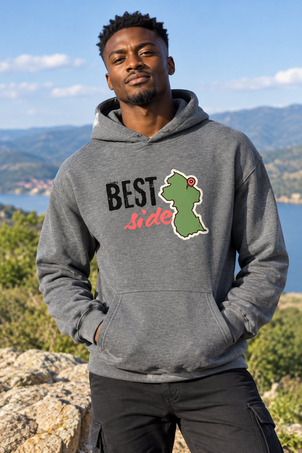 A heather gray pullover hoodie featuring a front graphic with the text 'BEST side' and a green outline map of Guyana with a red pin.