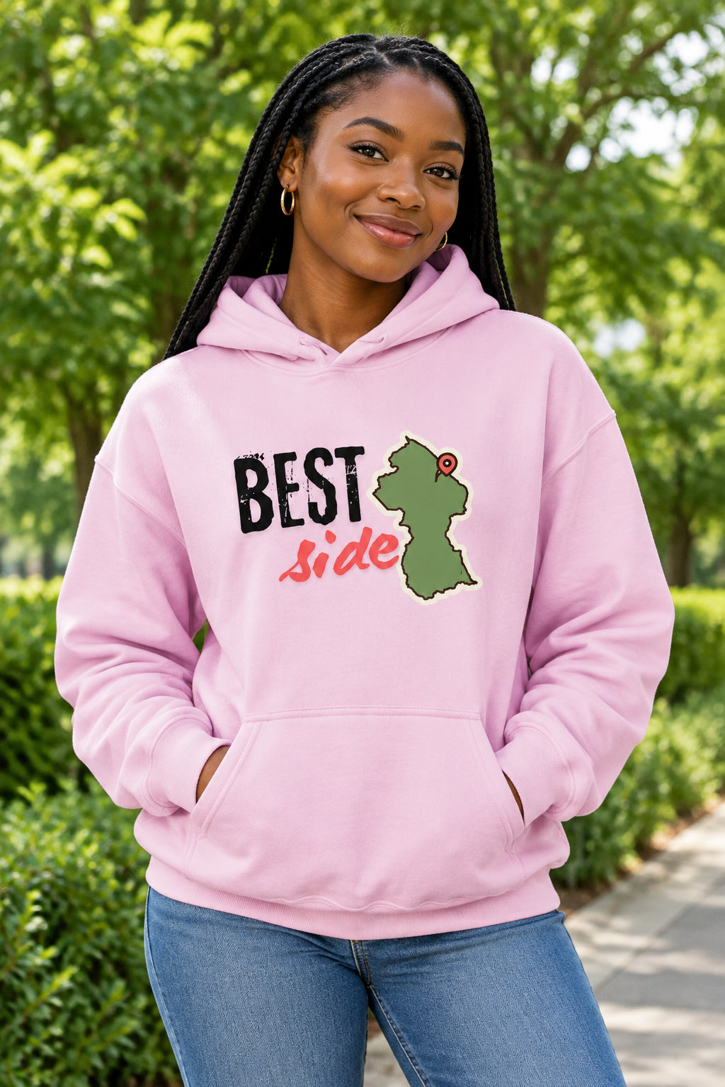 A light pink pullover hoodie with a graphic on the chest that reads 'BEST Side' in black and red text, alongside a green silhouette Guyana map shape with a red pin, shown on a plain white background.