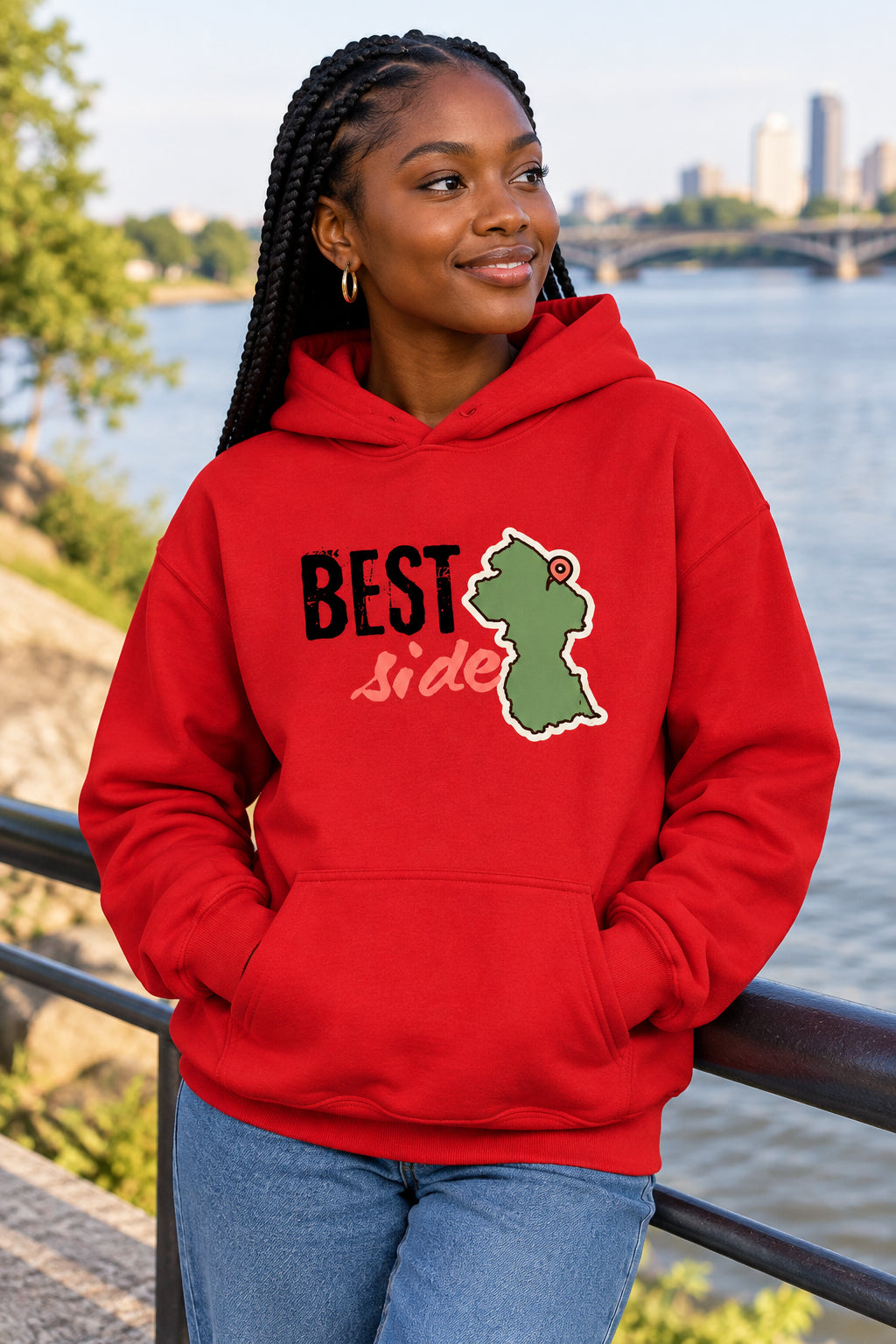 A red pullover hoodie with a front graphic that reads 'BEST side' in black and pink, alongside a green Guyana map silhouette outline. The hoodie is shown on a plain white background.