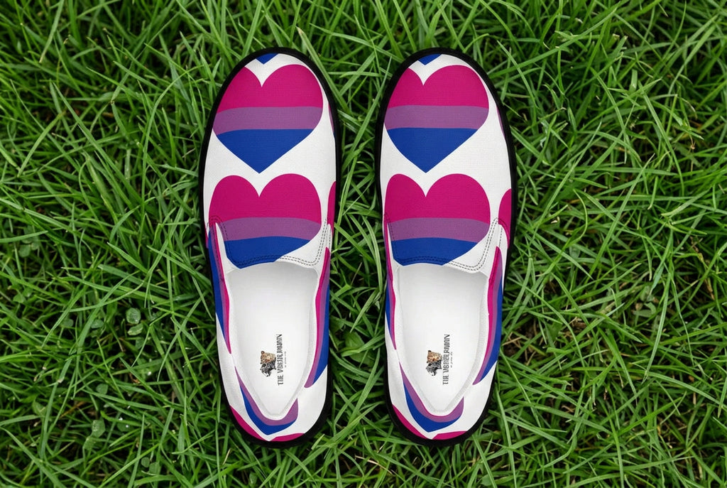White slip-on shoes with pink and blue heart designs on a white background
