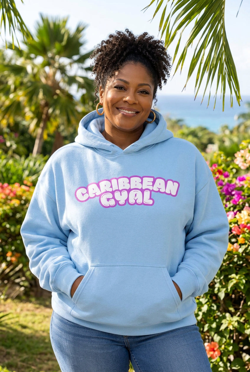 A light blue pullover hoodie with a front kangaroo pocket and a pink and white bubble-letter graphic reading 'CARIBBEAN GYAL' across the chest, shown on a plain white background.