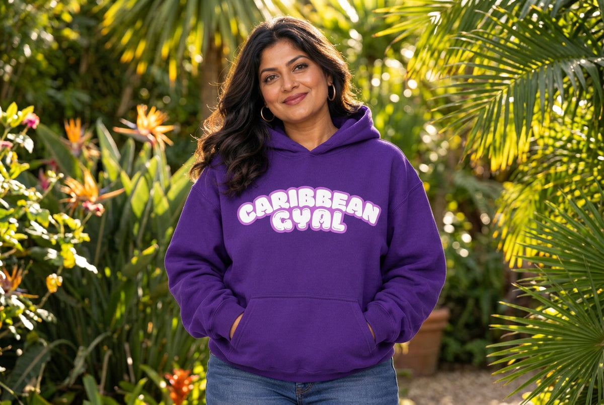 A purple pullover hoodie with 'CARIBBEAN GYAL' printed across the chest in white bubble letters with a pink outline, shown on a plain white background.