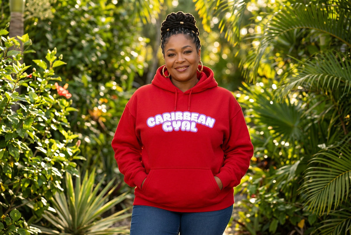 A bright red pullover hoodie with a front kangaroo pocket and a graphic text print reading 'CARIBBEAN GYAL' in white bubble letters with a pink and purple outline, displayed on a clean white background.