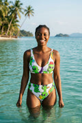 Bikini set with green alien print on a woman stainding in pool