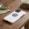 Phone case with eye design and marble pattern on a white background