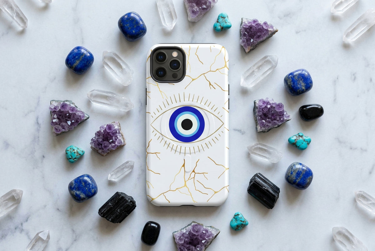 Phone case with eye design and gold fractures on a white background