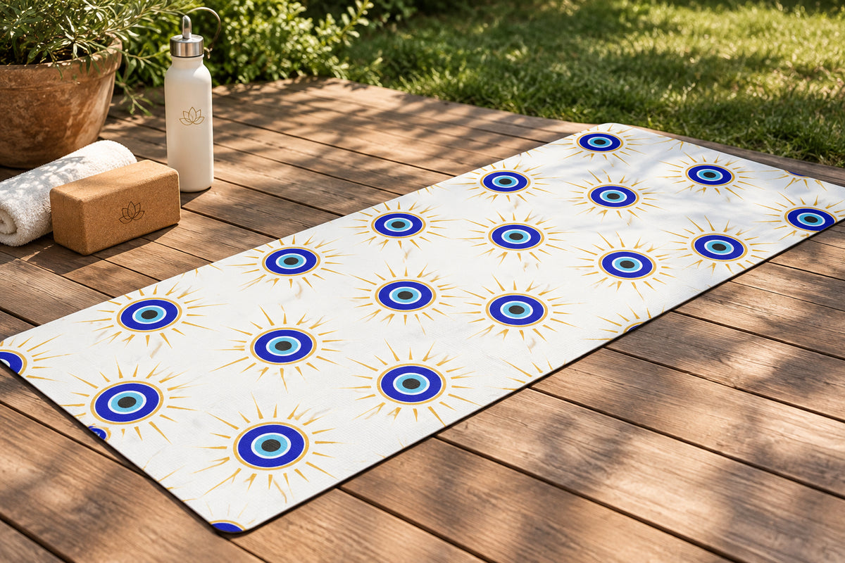 Patterned mat with blue and gold evil eye design on a white background