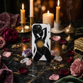 Phone case with black silhouette of a person and gold sun design on a white background