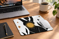 Mouse pad with abstract design featuring a sun and geometric shapes, accompanied by a mouse.