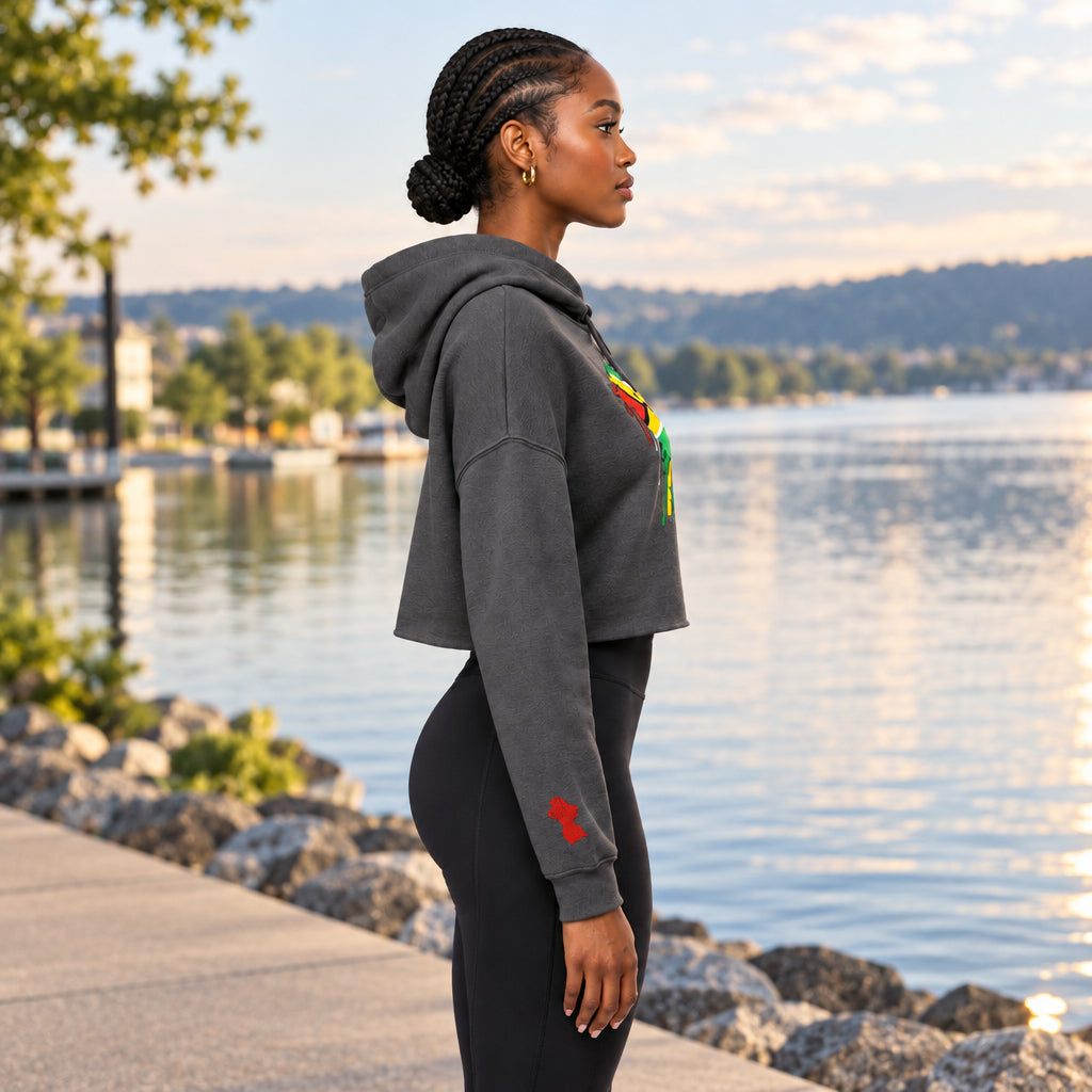 A grey cropped hoodie with a graphic of the Guyana flag forming a heart shape on the chest, with a dripping paint effect. The hoodie is shown against a plain white background