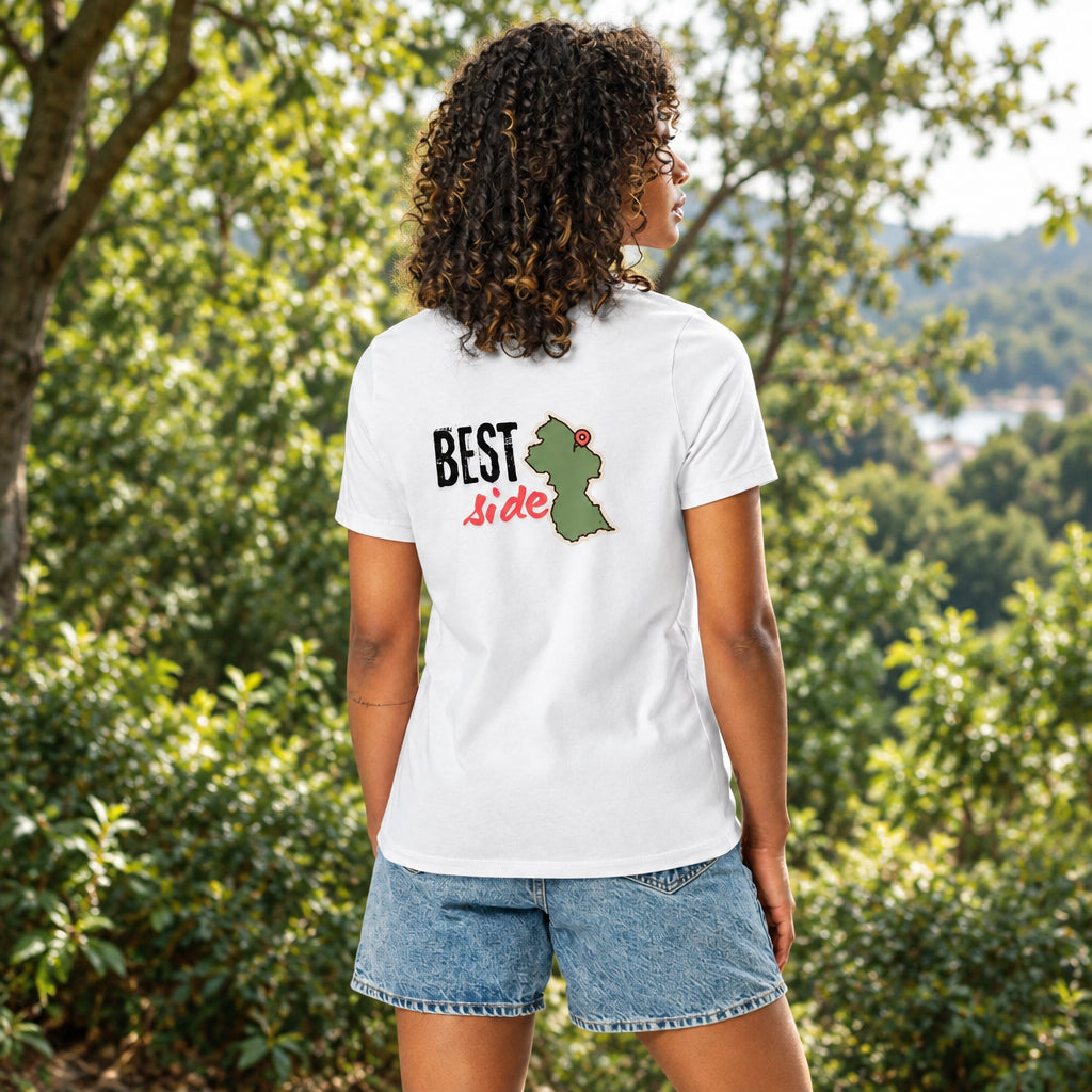 A woman shown from the back wearing a white short-sleeve T-shirt with a graphic on the back that reads “BEST Side” in black and red text beside a green Guyana outline map graphic, paired with denim shorts against a plain white background.