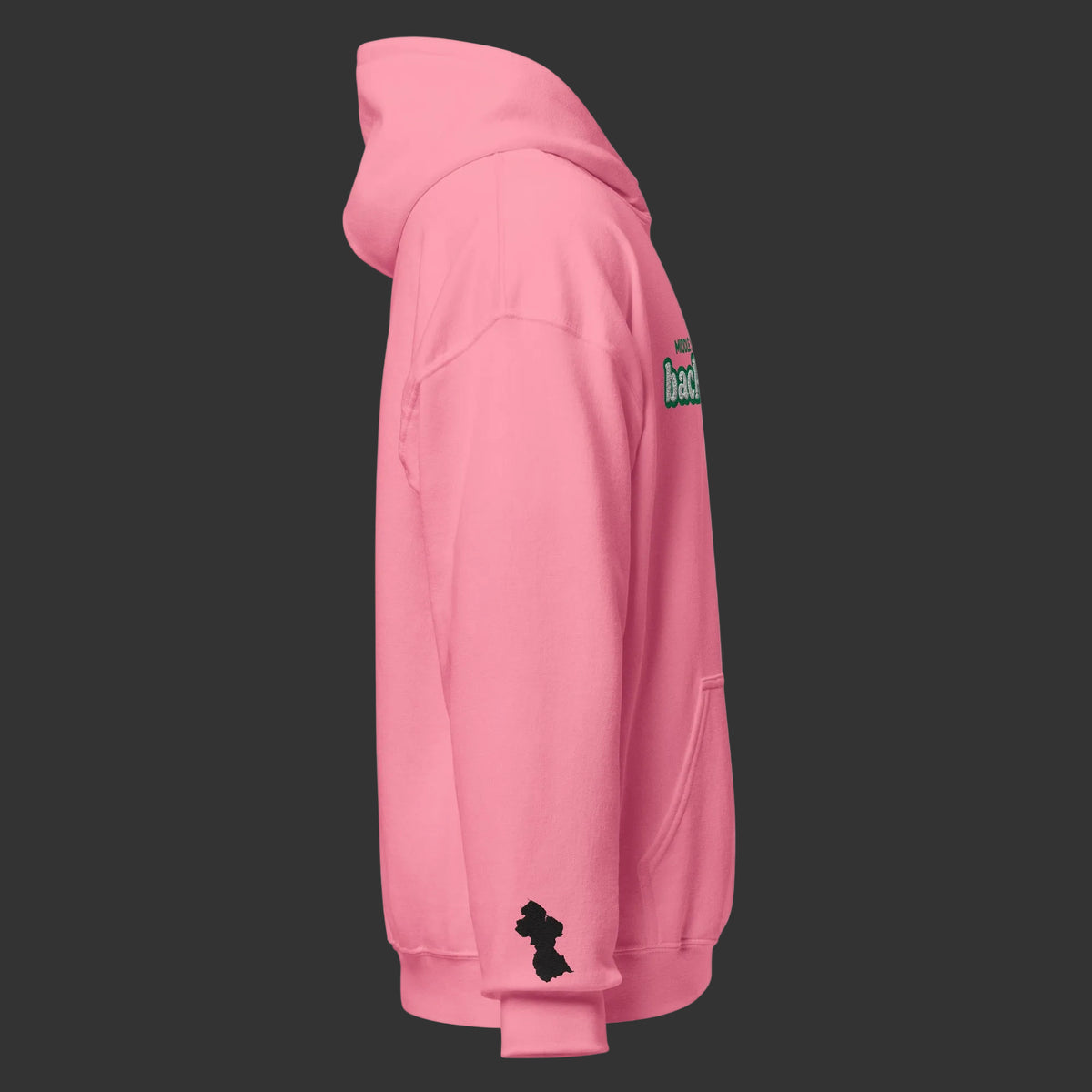 A pink pullover hoodie shown from the side profile on a solid white background, featuring a small black silhouette Guyana map  logo on the left sleeve and a small green and red graphic on the upper right shoulder.