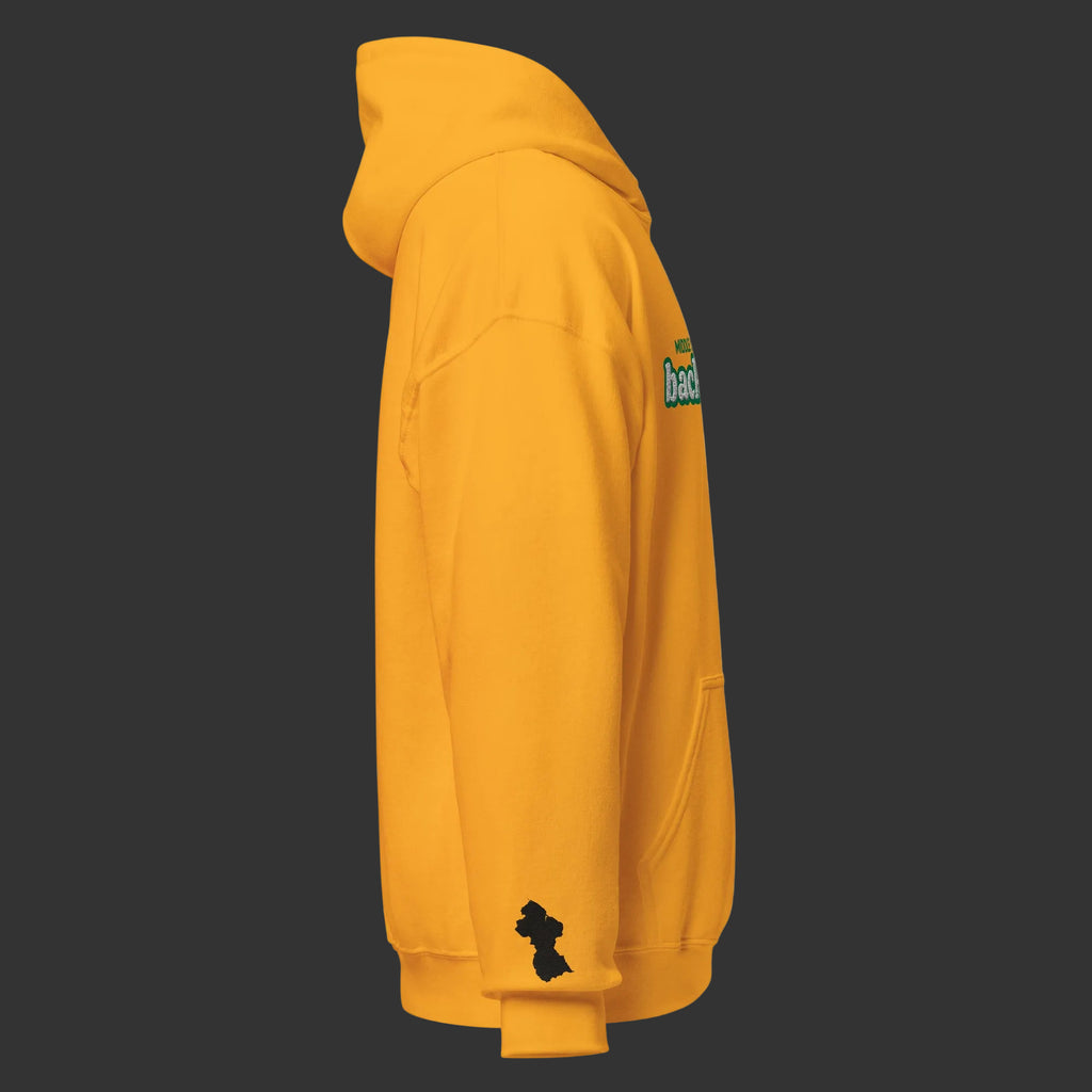 A side profile view of a gold hoodie featuring a small black silhouette logo on the left sleeve and a green and white graphic on the upper right shoulder, shown against a plain white background.