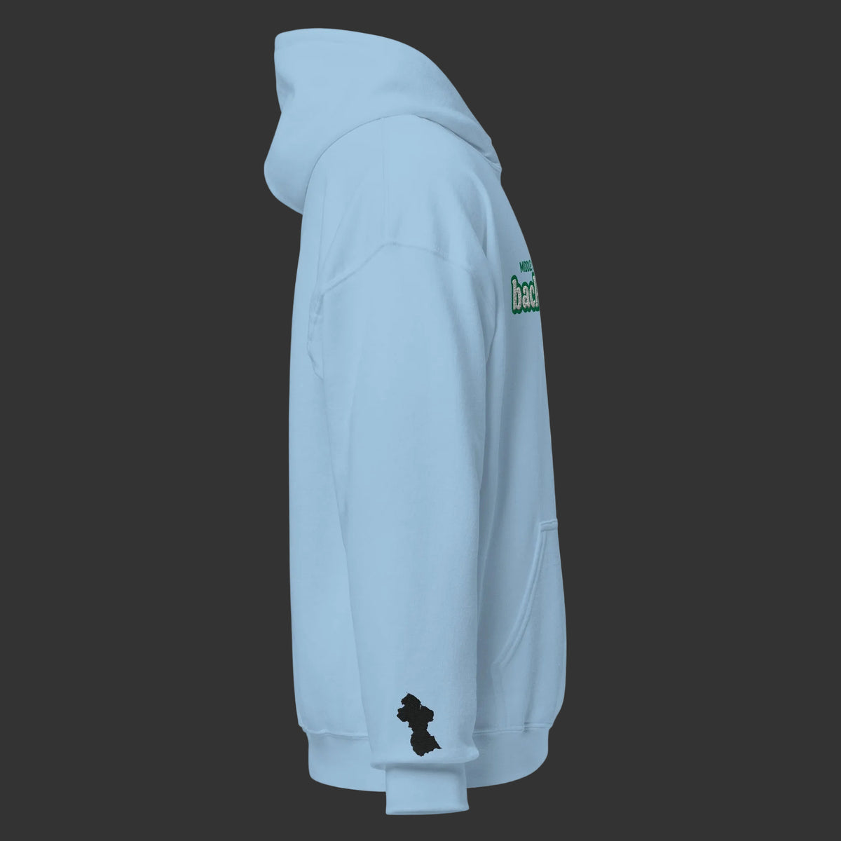 A light blue pullover hoodie shown from the side profile on a solid white background. The hoodie features a small black Guyana map silhouette graphic on the lower left sleeve and a green and white graphic on the upper right shoulder.