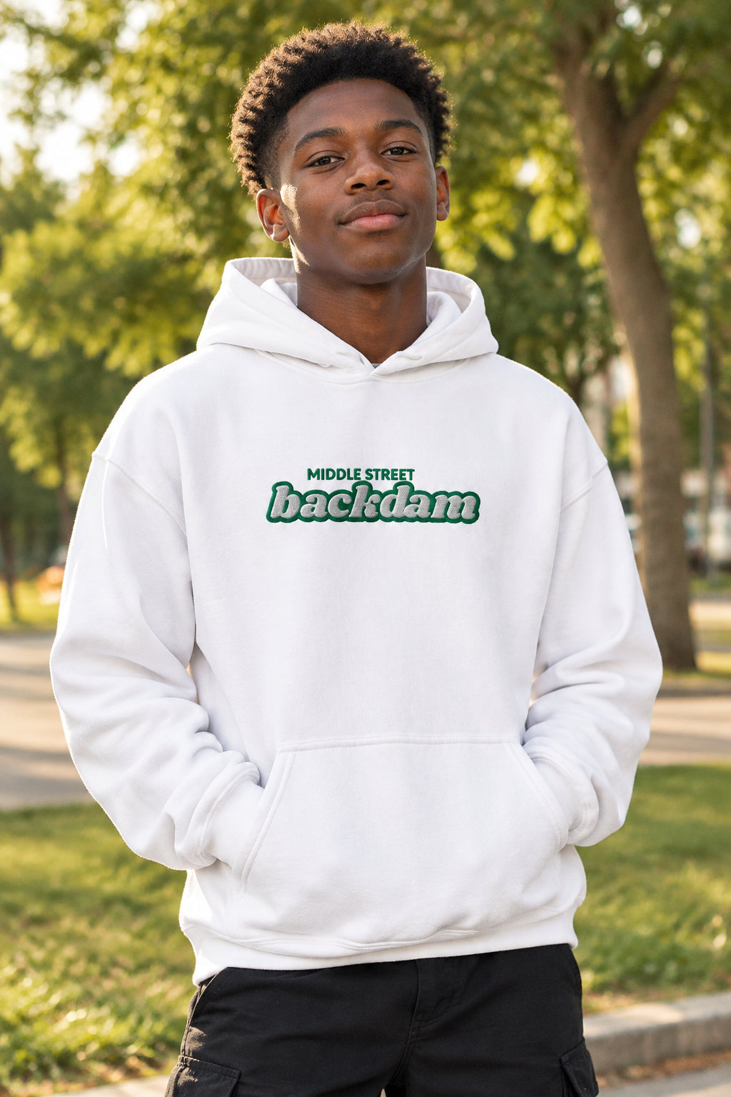 A white pullover hoodie with a front kangaroo pocket and a green chest graphic reading 'MIDDLE STREET backdam'.