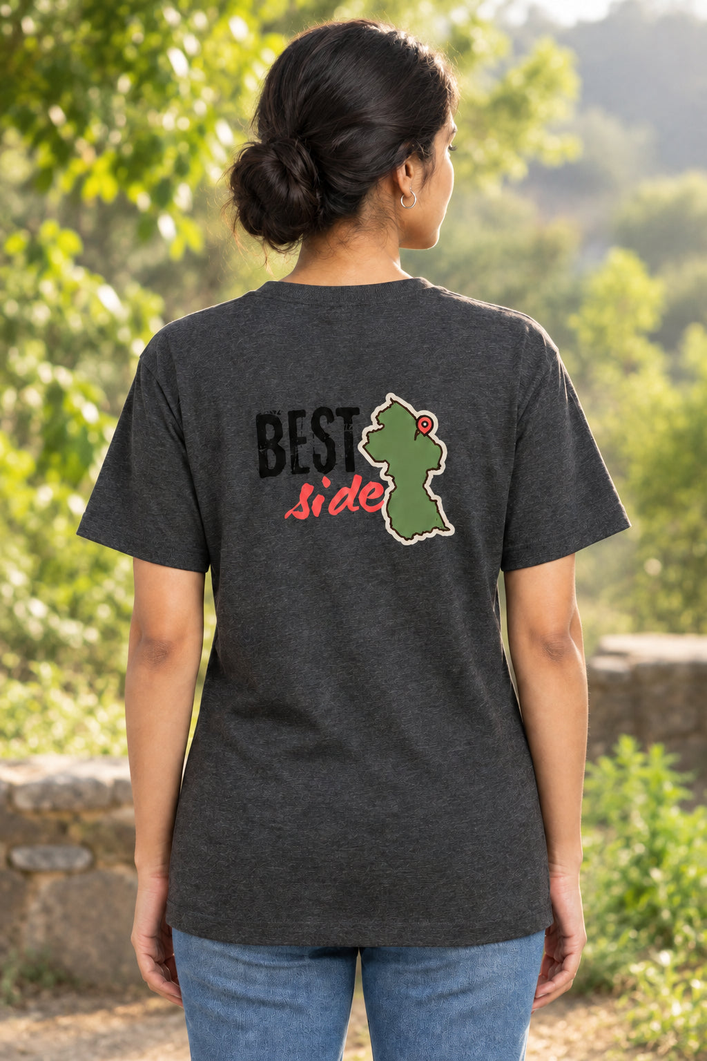 A dark heather gray t-shirt shown from the back, featuring a graphic print with the text 'BEST Side' and a green Guyana map outline with a red pin.