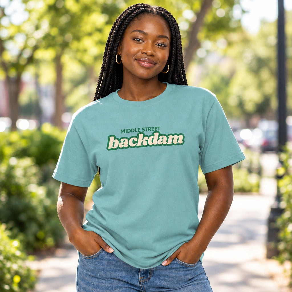 A light teal short-sleeve crewneck t-shirt featuring a graphic print on the chest that reads 'MIDDLE STREET backdam' in green and white.