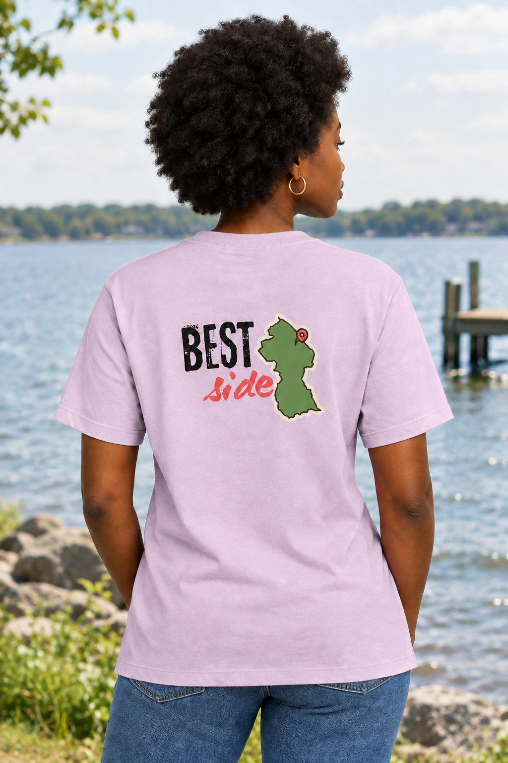 A light pink short-sleeve t-shirt shown from the back, featuring a graphic print with the text 'BEST Side' and a green Guyana map outline.