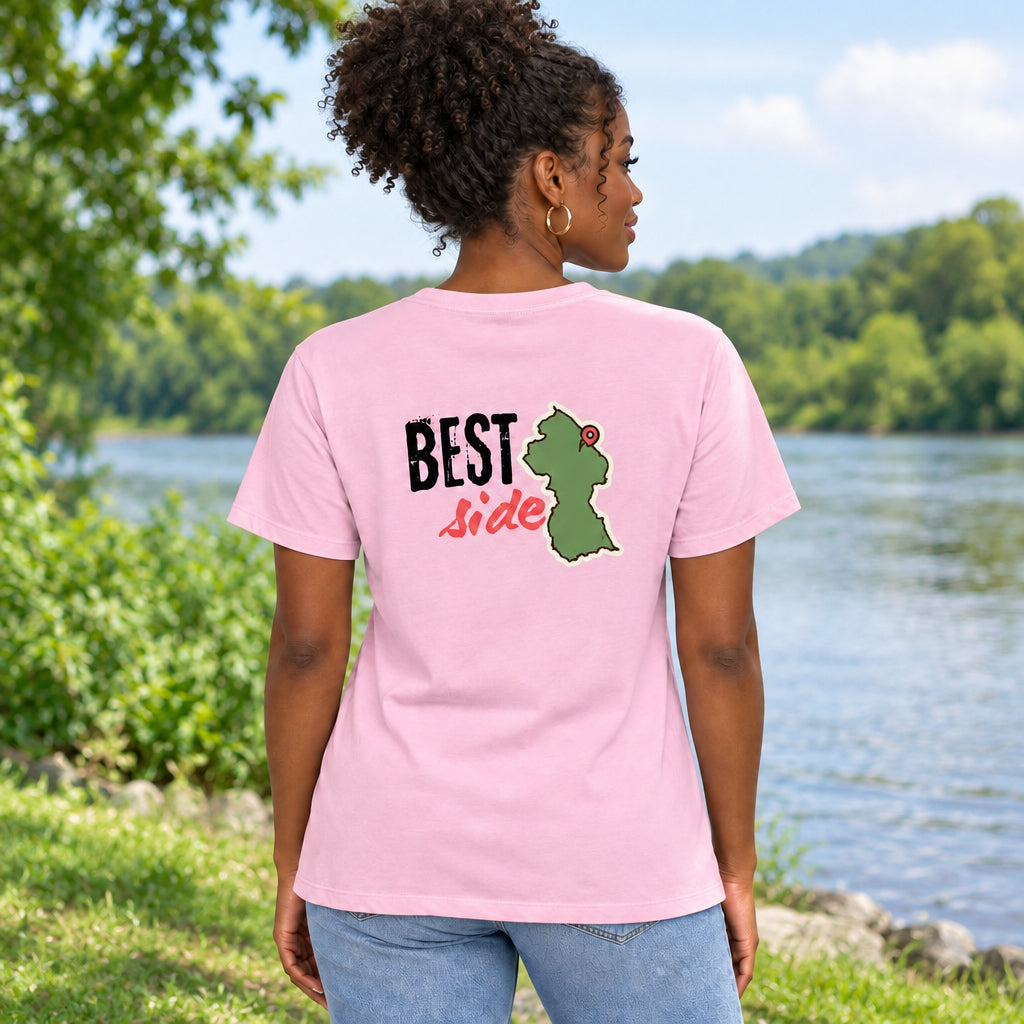 A light pink short-sleeve t-shirt shown from the back, featuring a graphic print with the text 'BEST Side' and a green Guyana map outline with a red pin.