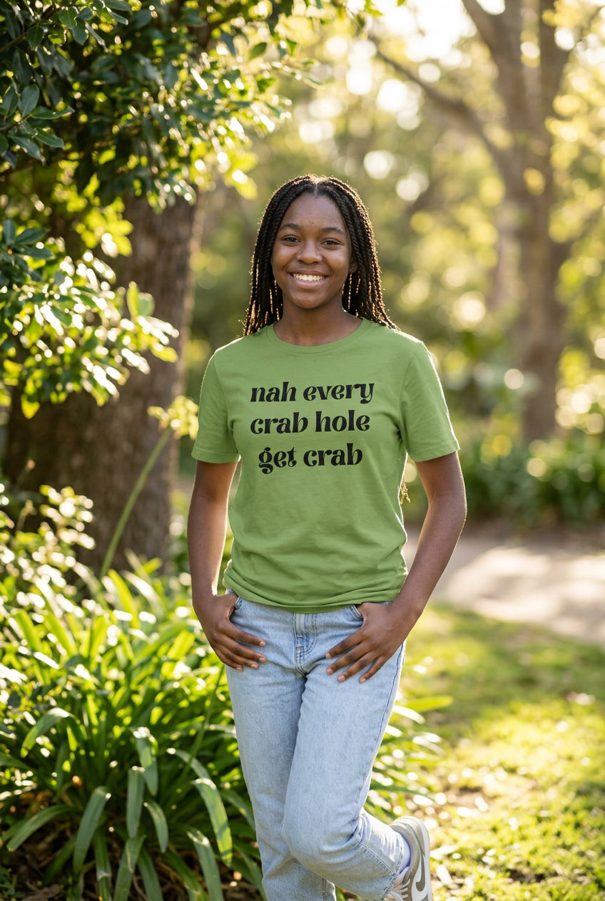 Green t-shirt with 'Nah every crab hole get crab' black text on a white background