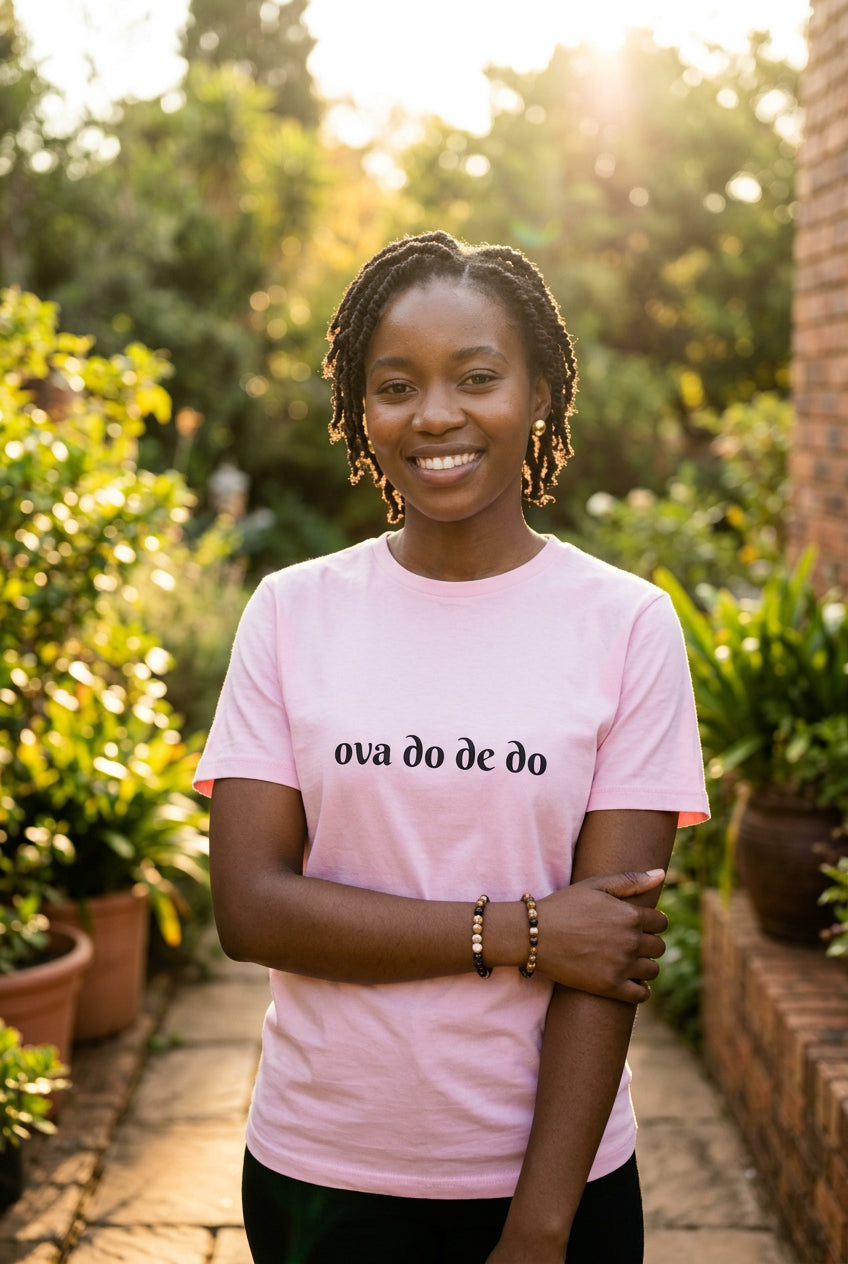 Pink t-shirt with black 'ova do de do' text on a white background