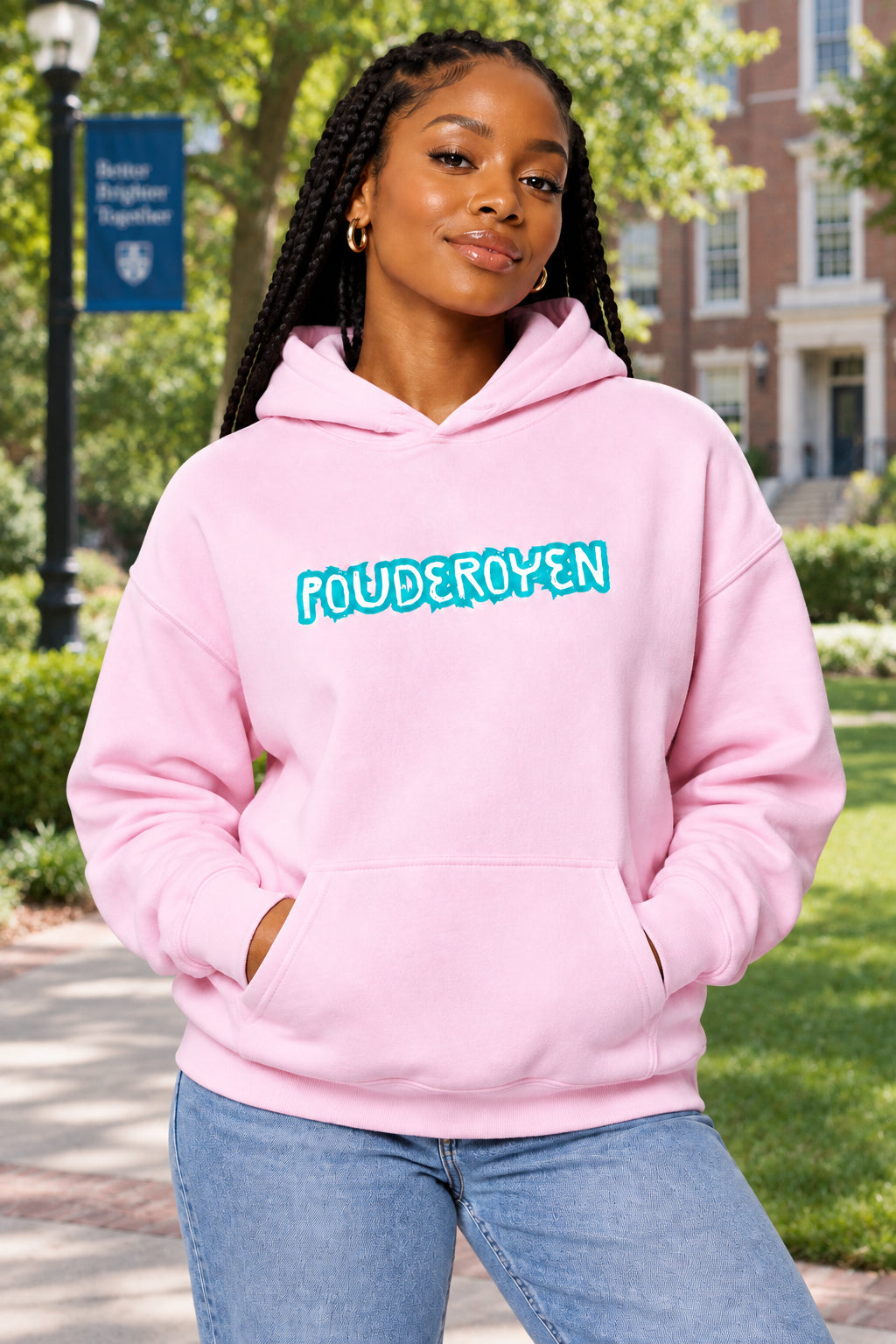 A light pink pullover hoodie with the word 'POUDEROYEN' printed across the chest in a stylized turquoise font with a white outline. The hoodie features a front kangaroo pocket and ribbed cuffs and hem, shown against a plain white background.