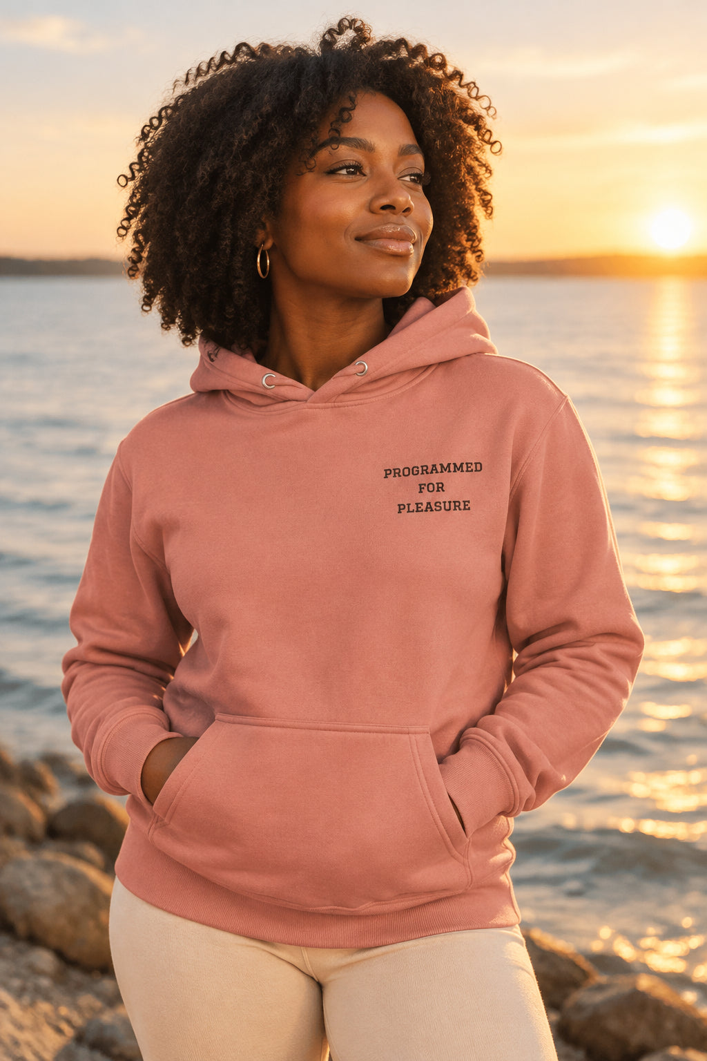 Coral hoodie with a colorful logo on the chest against a white background