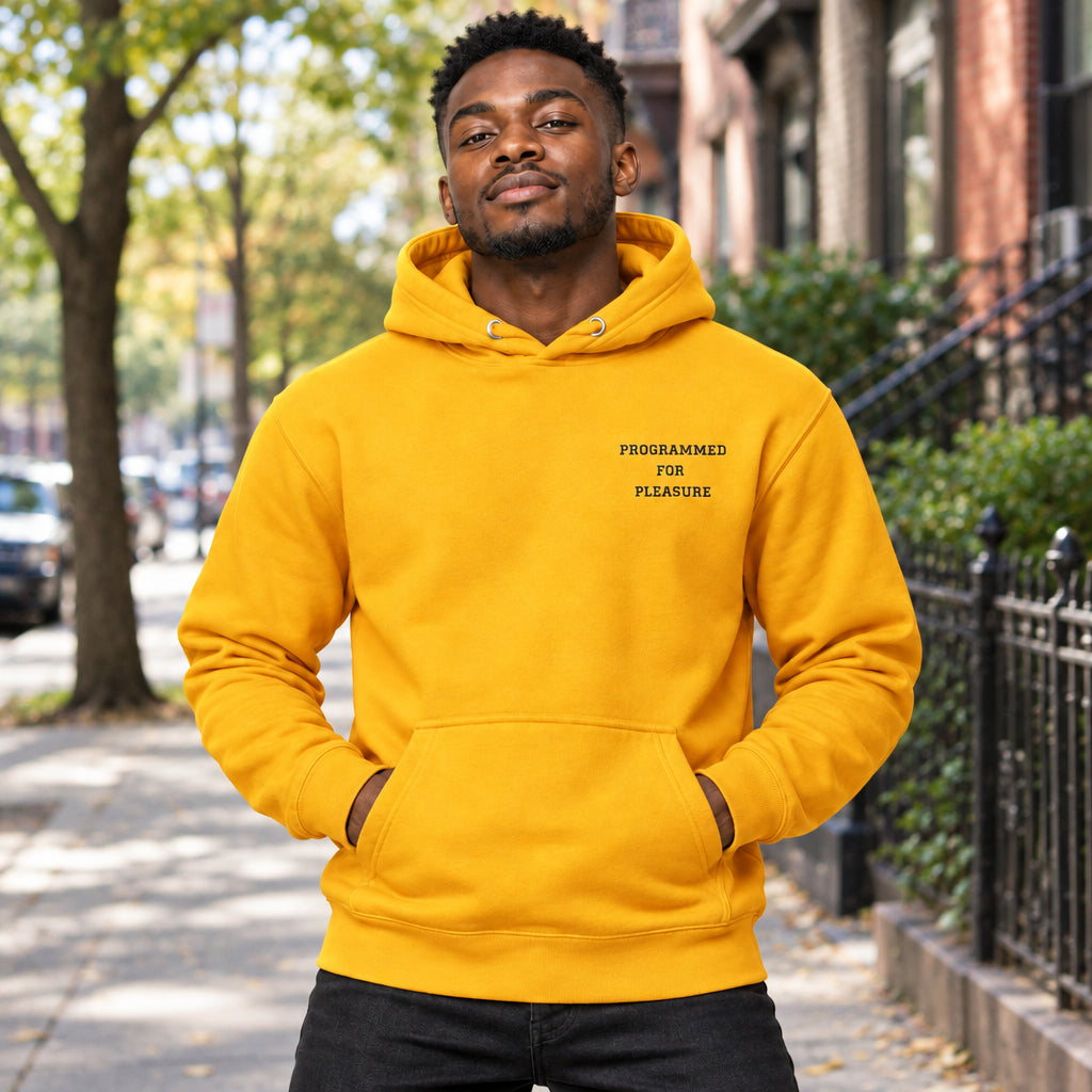 Gold hoodie with text 'PROGRAMMED FOR PLEASURE' on a white background