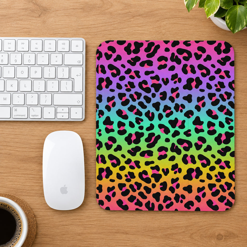 Colorful leopard print mouse pad next to a keyboard and mouse on a white background