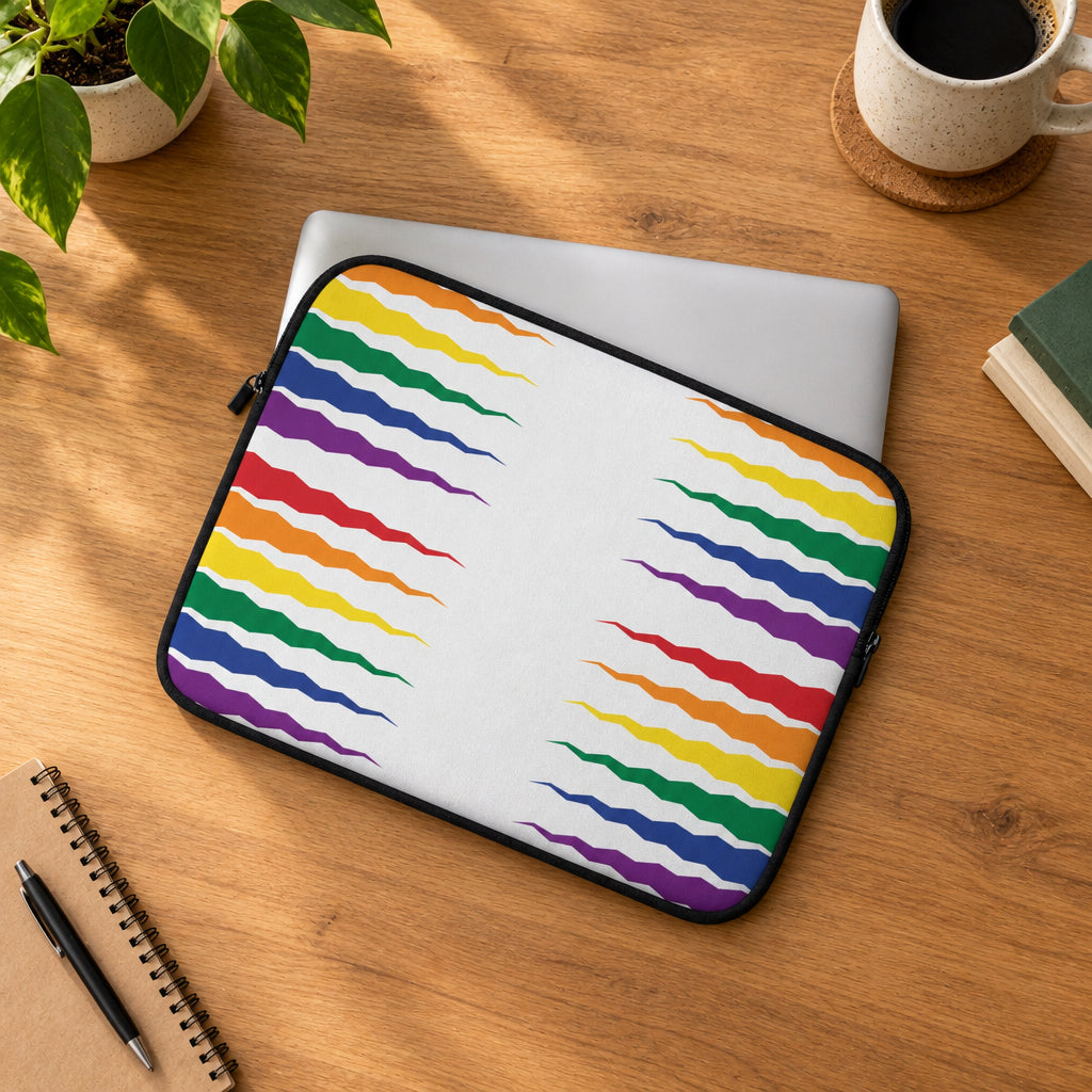 Laptop sleeve with rainbow wave pattern on a light gray surface with green leaves.